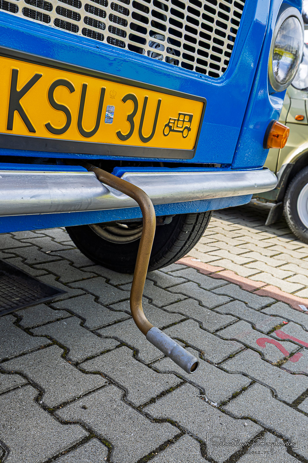 A blue Nysa van converted into a pickup with a wooden bed, later the stage for a contest to see how many people could fit on it (2/2)