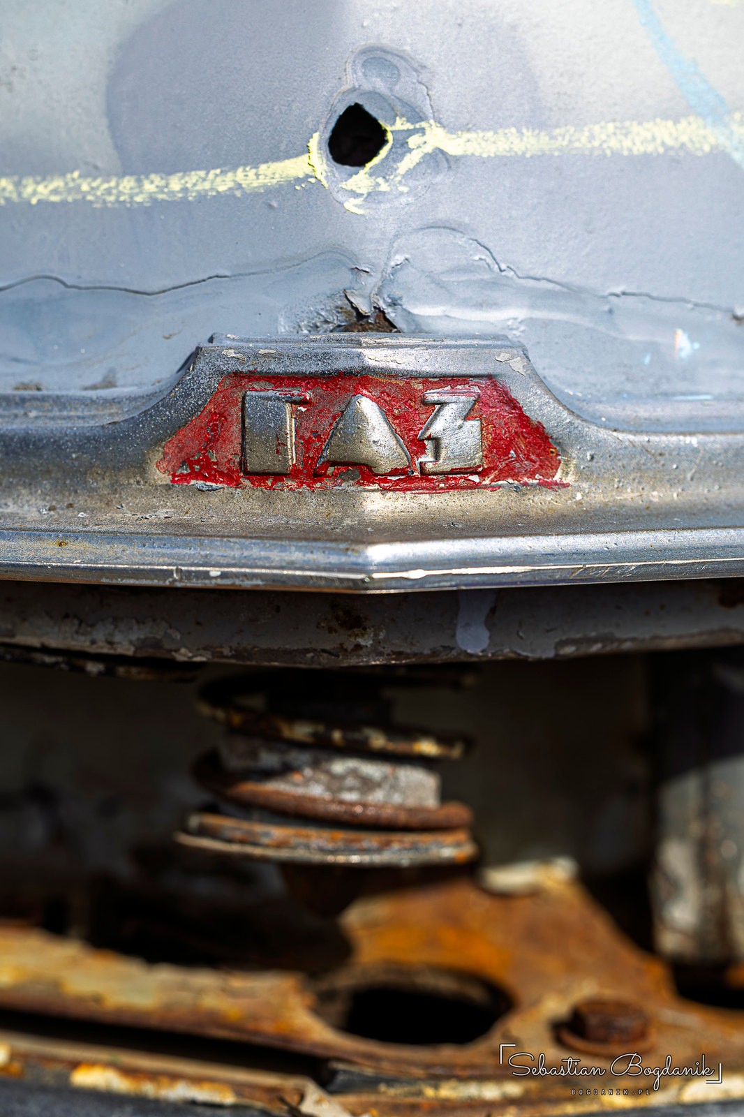 The Pobeda up close: the Cyrillic name means “Victory,” next to a well-weathered GAZ badge (2/2)