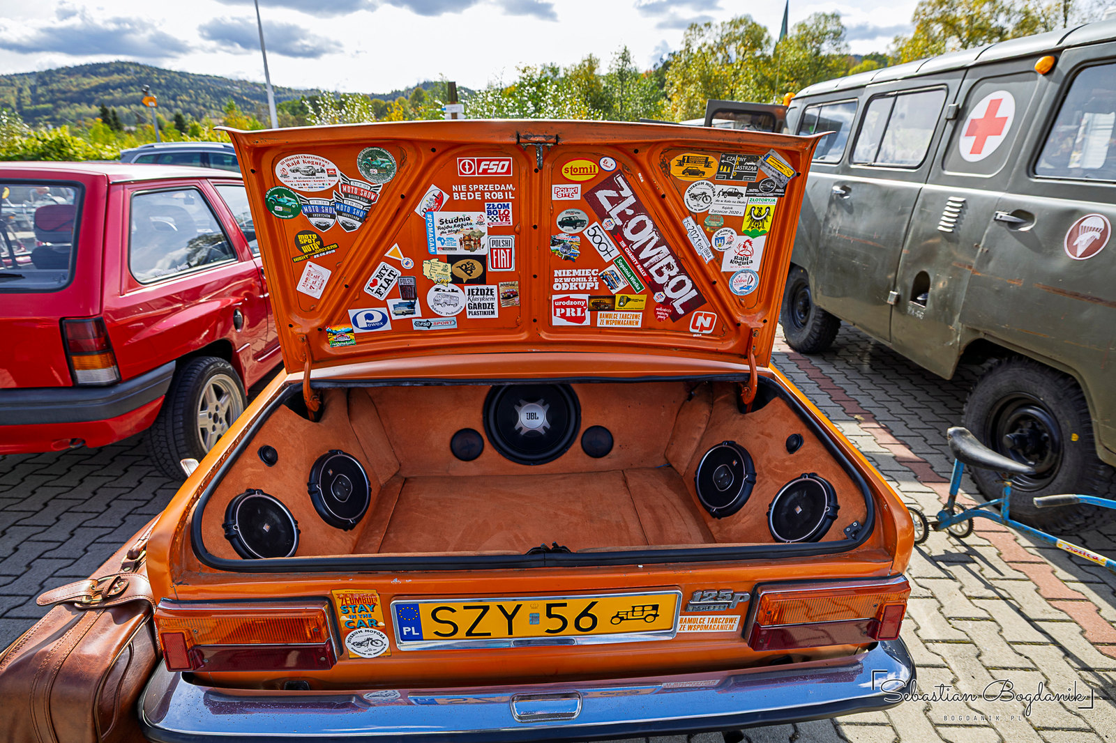 A trunk full of speakers and a lid full of stickers