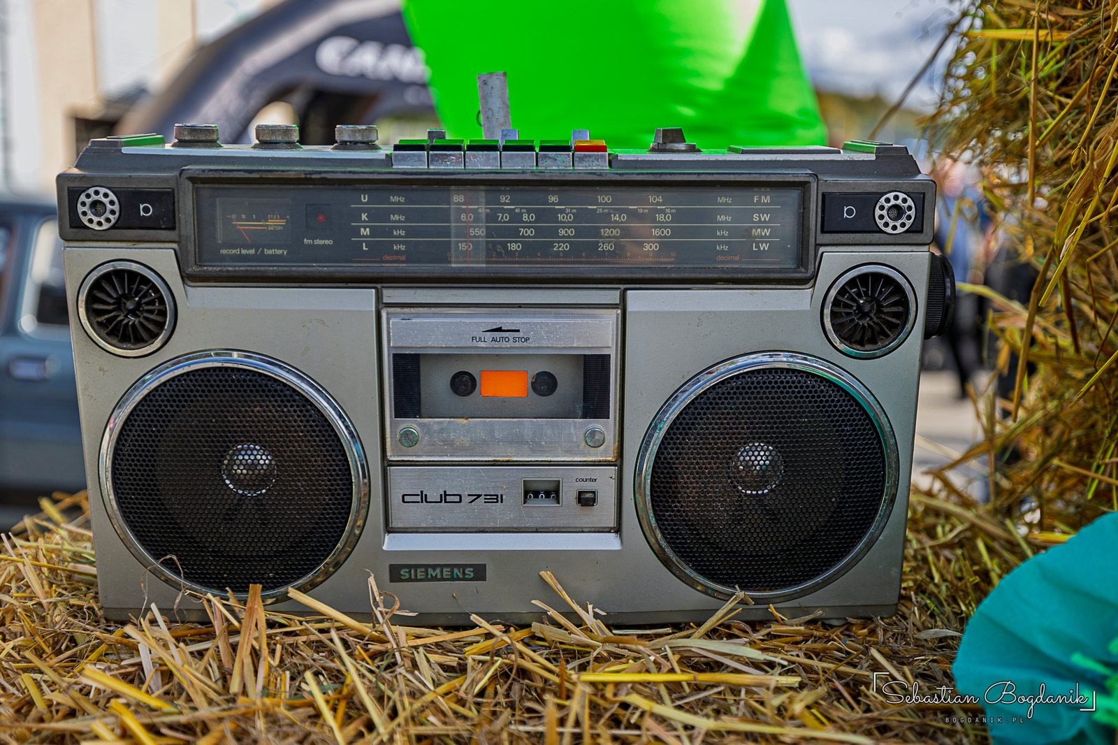 A Siemens boombox on a bale of straw